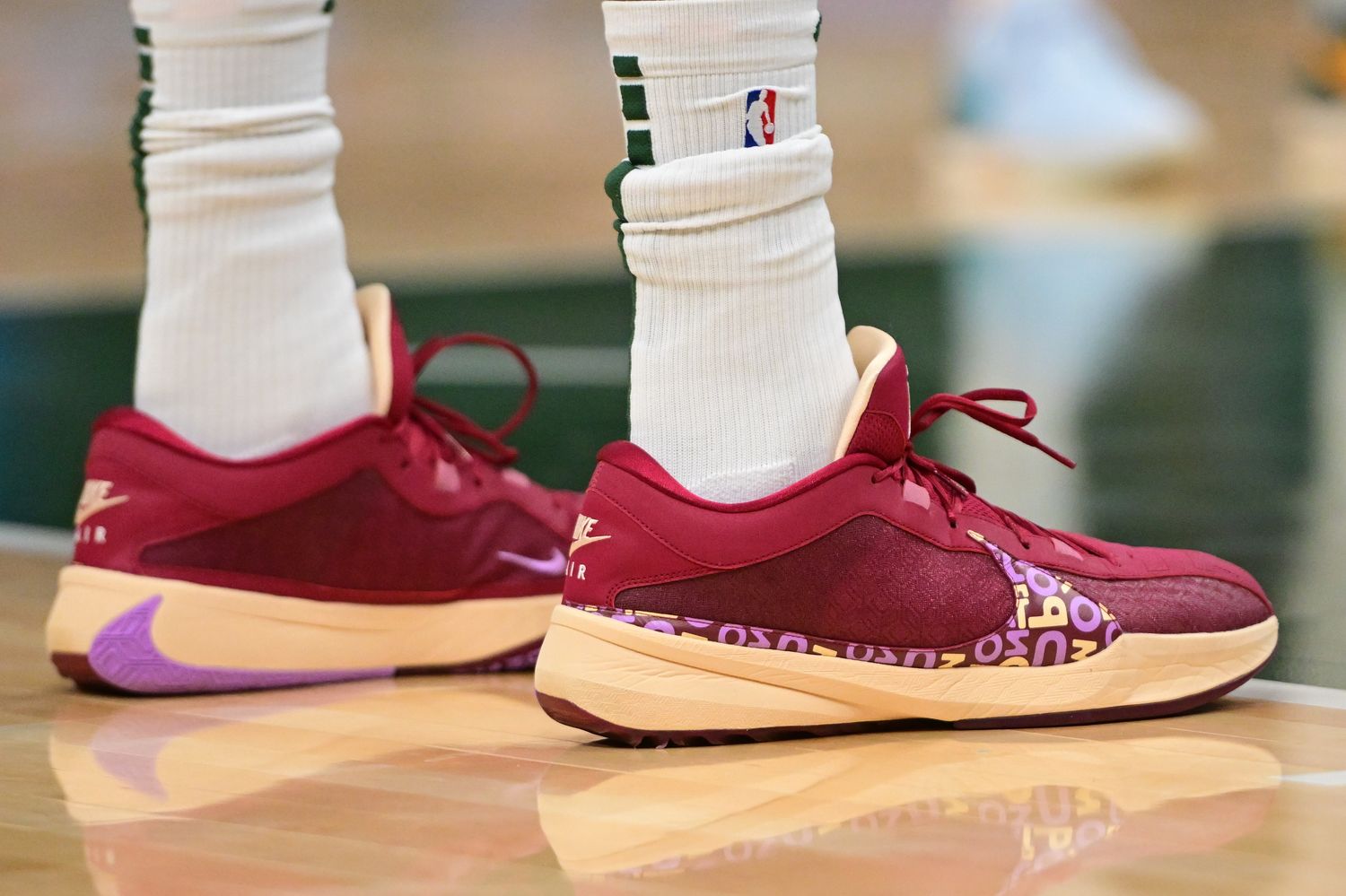 Milwaukee Bucks forward Giannis Antetokounmpo's red and orange Nike shoes.